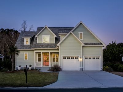 Front elevation of beautiful home lit up at twilight.